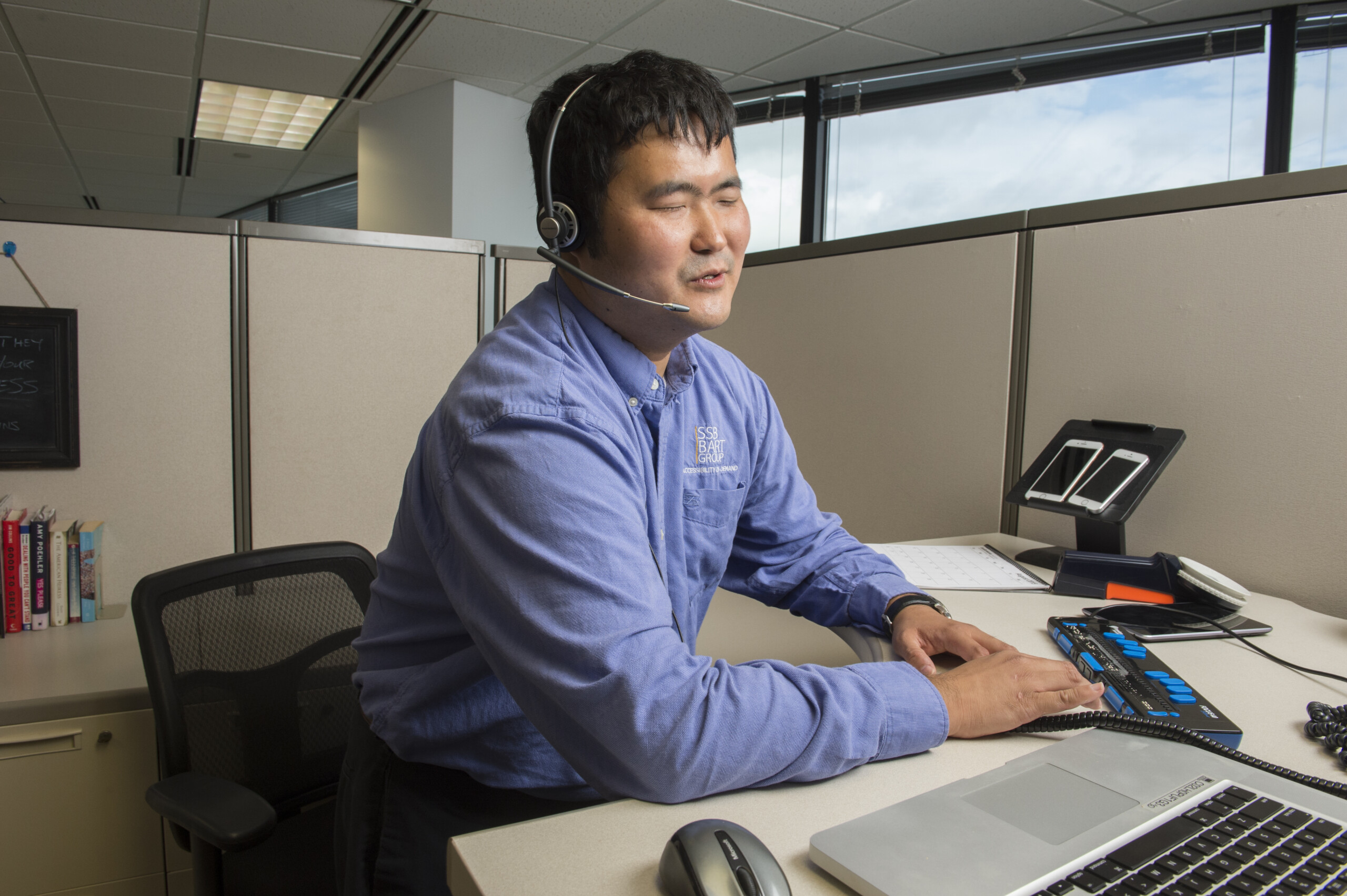 Blind Employee using technology in cubicle