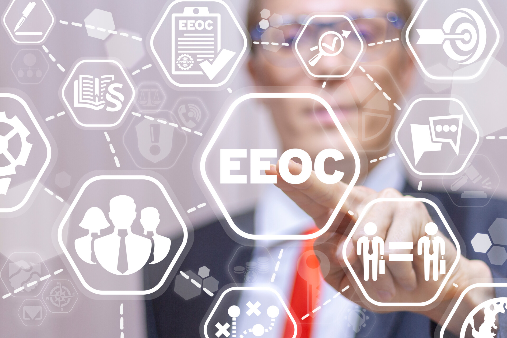 Business man tapping on a white hexagon with acronym EEOC centered